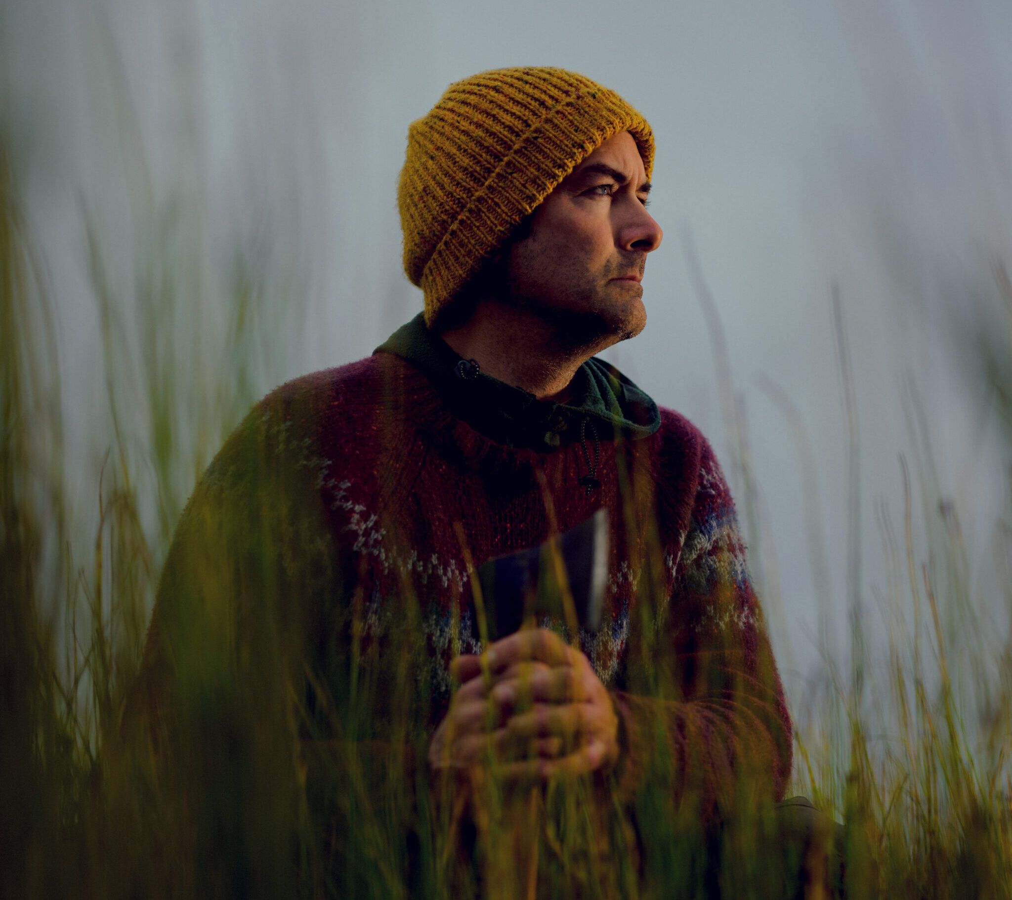 Dub Paetz kneeling in horsetail grass in the Arctic