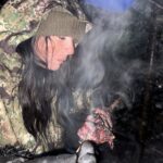 Eating a piece of meat on a survival trip